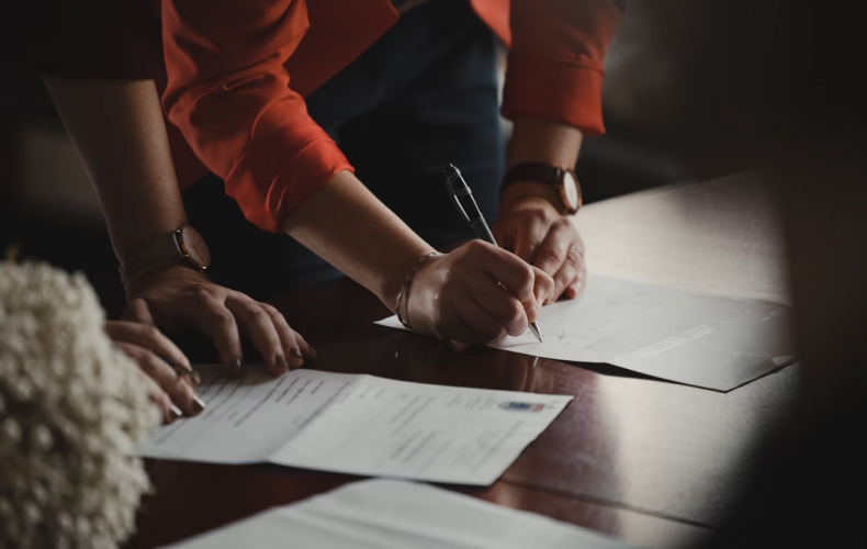 Woman signing a dance studio waiver template