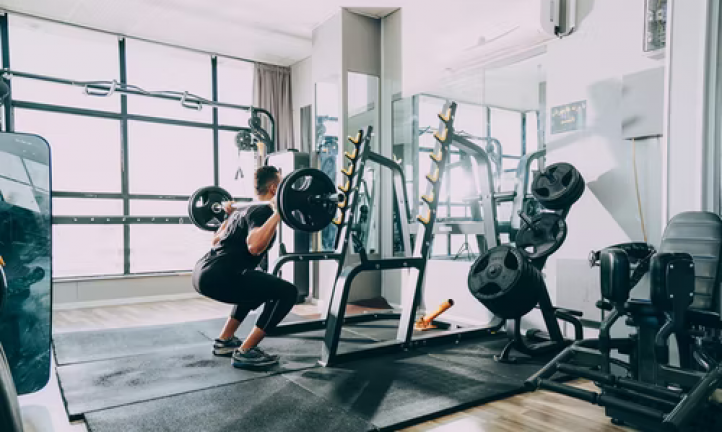 Man lifting a barbell in a gym