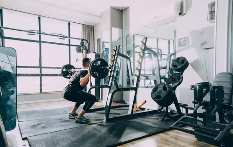 Man lifting a barbell in a gym