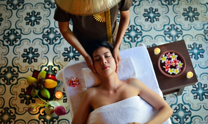 a woman giving head massage to another woman